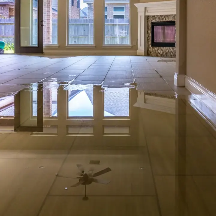 Standing water across a tile living room floor in a Parker County home