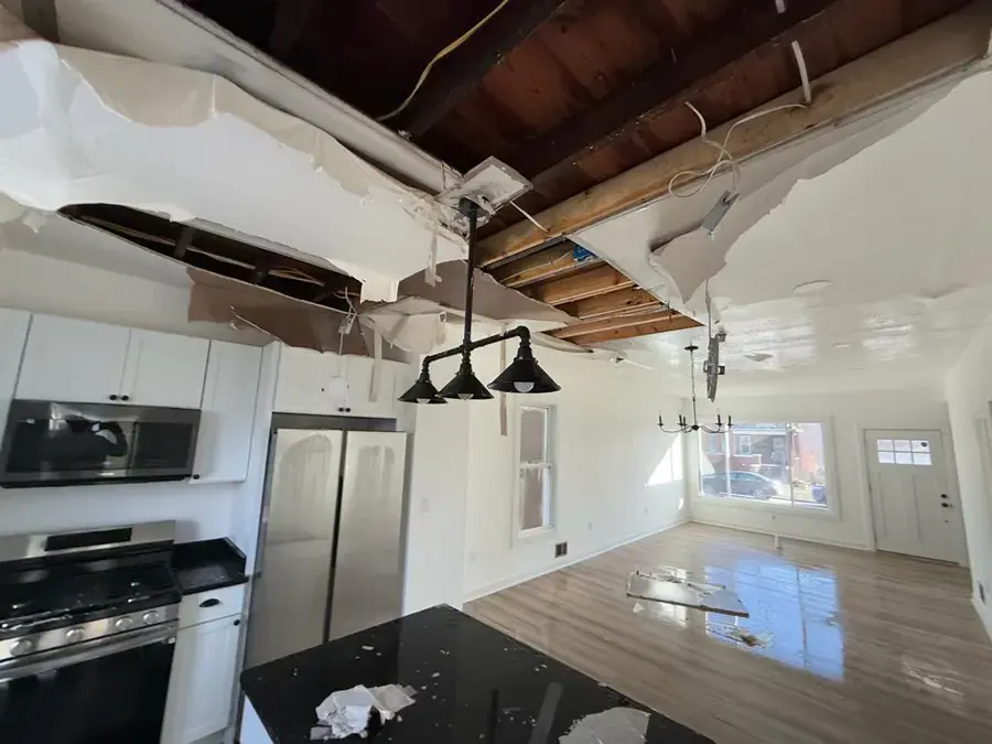Kitchen ceiling torn open by a water leak from above in a Weatherford home